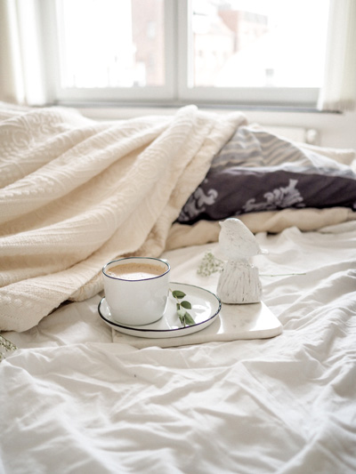 luxury bedding with cup of coffee